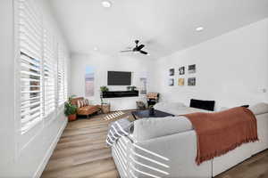 Living room featuring wood finished floors, recessed lighting, and a ceiling fan