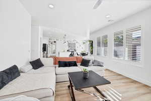 Living area featuring light wood finished floors, recessed lighting, and a ceiling fan