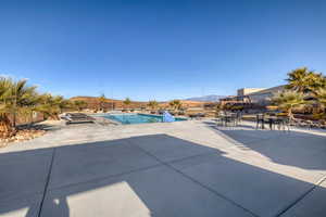 Swimming pool featuring a patio area and a mountain view
