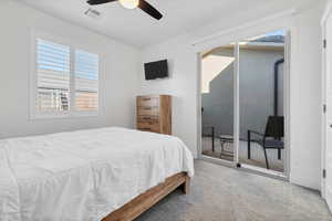 Carpeted bedroom with access to outside and ceiling fan