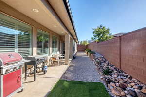 Fenced backyard featuring grilling area