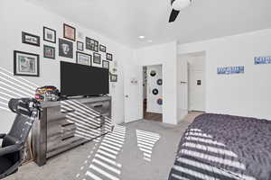 Bedroom with light carpet and ceiling fan