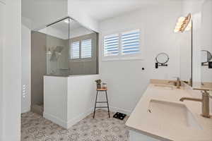 Bathroom featuring a walk in shower and double vanity