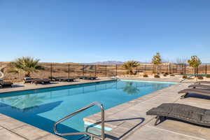 Community pool with a patio area and a mountain view