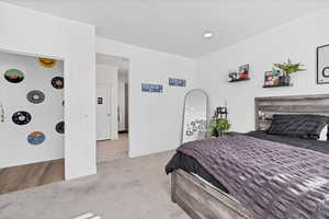 Bedroom with light colored carpet and baseboards