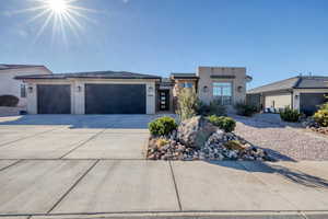 View of front of home with stucco siding, driveway, and an attached garage