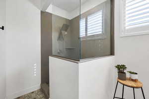 Full bath with walk in shower and baseboards