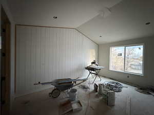 Interior space featuring lofted ceiling and wooden walls