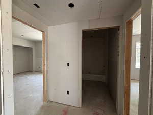 Looking into hallway where bathroom (middle) and 2 bedrooms are at the bottom of the stairs (left and right)