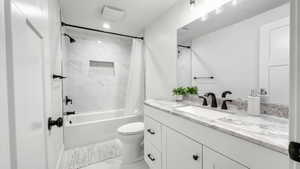 Full bath featuring shower / bath combination with curtain, vanity, and recessed lighting