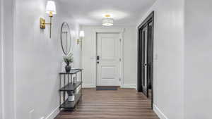 Hall with dark wood-style floors and a textured ceiling