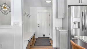 Mudroom with wood finished floors and baseboards
