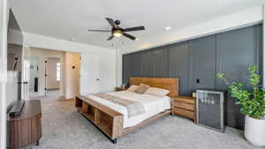 Bedroom with beverage cooler, light carpet, ceiling fan, recessed lighting, and a textured ceiling