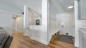 Mudroom with light wood finished floors, recessed lighting, a chandelier, and lofted ceiling
