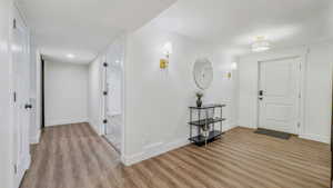 Foyer entrance featuring baseboards and light wood-style floors