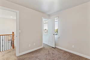 Unfurnished bedroom with baseboards and carpet