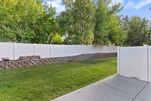 Fenced backyard with a patio