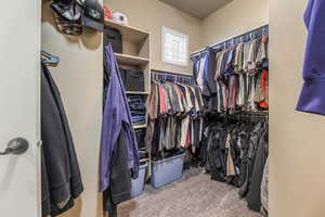 Walk in closet featuring light carpet