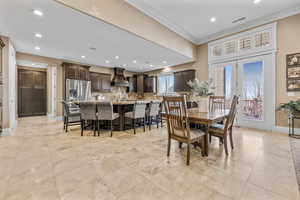 Dining area with recessed lighting and crown molding