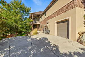 Patio / terrace with a garage and driveway