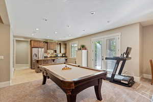 Playroom with pool table, recessed lighting, french doors, a textured ceiling, and light colored carpet