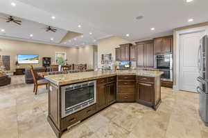 Kitchen featuring open floor plan, appliances with stainless steel finishes, recessed lighting, a large island, and a ceiling fan