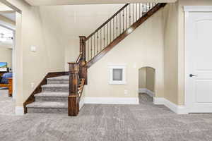 Stairway featuring carpet floors and baseboards
