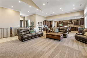 Living area featuring recessed lighting and ornamental molding