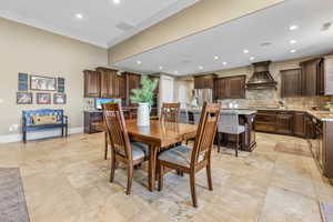 Dining room featuring recessed lighting and ornamental molding