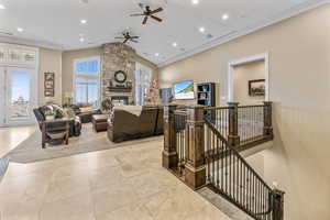 Living area featuring ornamental molding, a fireplace, recessed lighting, light tile patterned floors, and ceiling fan