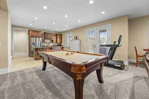 Game room with recessed lighting, pool table, light colored carpet, and french doors