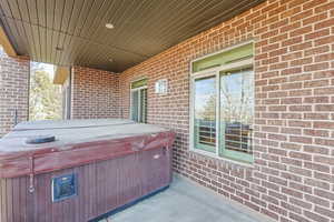 View of patio featuring a hot tub
