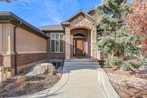 Entrance to property featuring stone siding