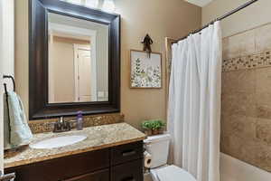 Bathroom with vanity and shower / bath combo