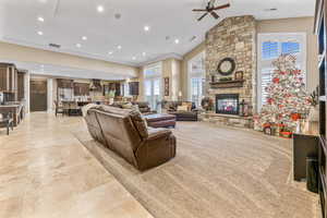 Living room with a fireplace, high vaulted ceiling, a ceiling fan, and recessed lighting