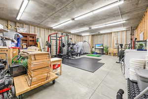 Workout area with concrete flooring and washer / clothes dryer