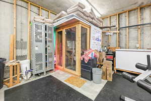 Basement with a sauna and white fridge