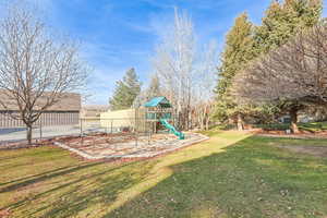 View of yard featuring a playground and a trampoline
