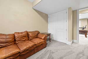 Living room featuring light colored carpet and baseboards