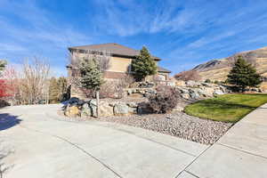 View of side of home featuring brick siding and a yard