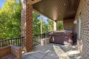 View of patio with a hot tub