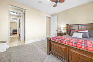Bedroom with light colored carpet and ceiling fan