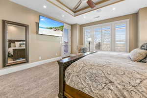 Bedroom featuring light colored carpet, access to exterior, recessed lighting, ceiling fan, and a raised ceiling
