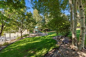 View of yard with a playground and a patio area