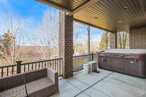 View of patio / terrace with a hot tub