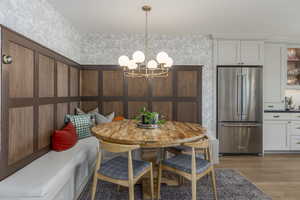 Dining room featuring light wood finished floors and a chandelier