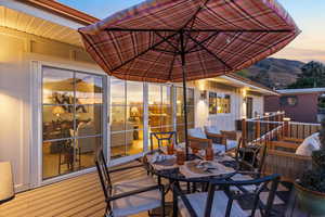 Wooden deck with a mountain view, an outdoor living space, and outdoor dining area