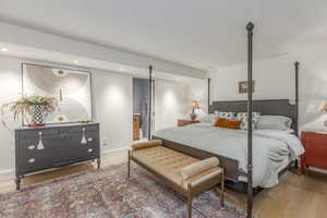 Bedroom with wood finished floors and recessed lighting