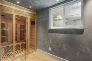 Sauna featuring wood finished floors and baseboards