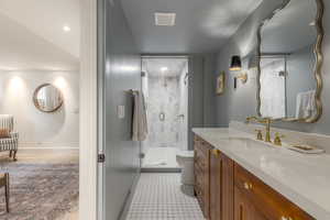 Bathroom featuring a stall shower and vanity